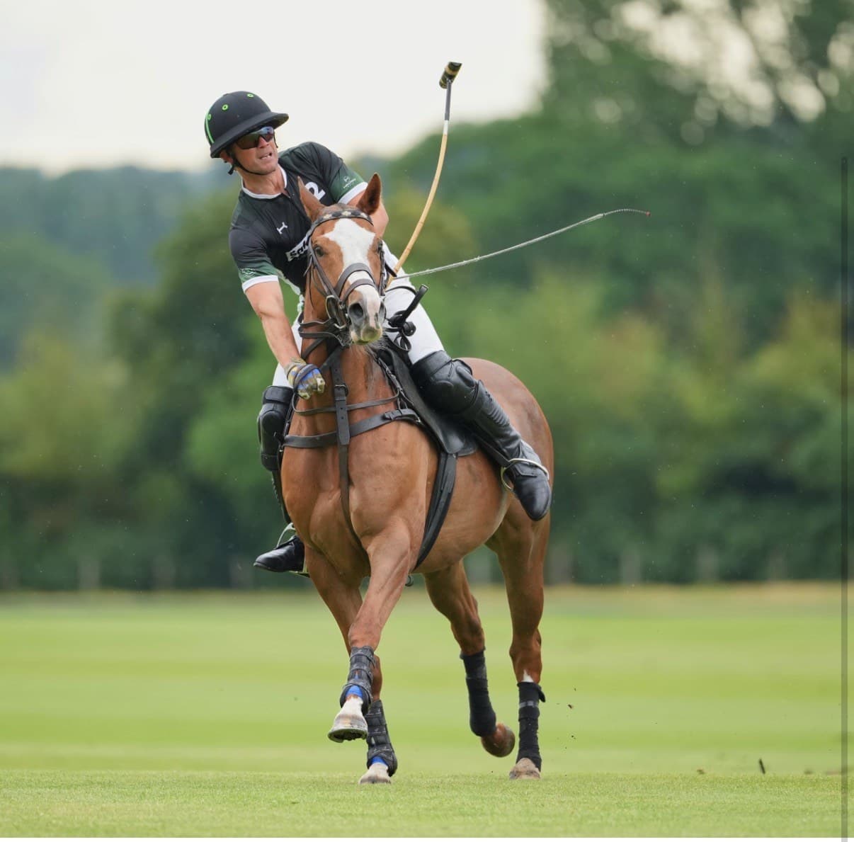 A SafeRock® Polo Team player mid-swing at Cowdray Park